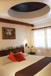 a bedroom with a bed with a large ceiling at Hotel Posada Real Tapalpa in Tapalpa