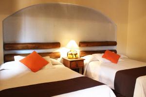 Postel nebo postele na pokoji v ubytování Hotel Posada Real Tapalpa