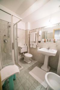 a bathroom with a sink and a toilet and a shower at Hotel Victoria in Taormina