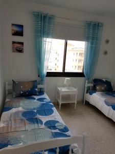 a bedroom with two beds and a window at Kings Avenue - Natalia's Apt in Paphos +17 photos