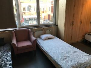 
a bed sitting in a room next to a window at Apartment Zaventem Brussels Airport D in Zaventem
