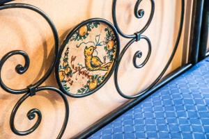 a metal bench with a plate with a bird on it at Hotel Victoria in Taormina