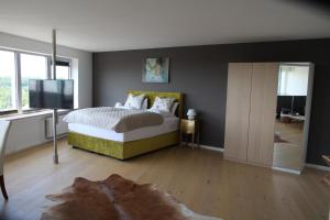 a bedroom with a bed and a flat screen tv at Ferienappartments Schleswig in Schleswig