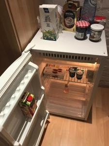 an open refrigerator with its door open with food inside at Apartment Zaventem Brussels Airport D in Zaventem