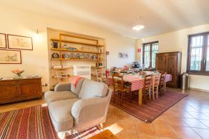 a living room with a table and a dining room at Cascina Gaggioli in Milan