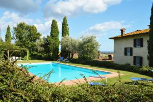 a large swimming pool in front of a house at Villa Al Fanucchi in Capannori