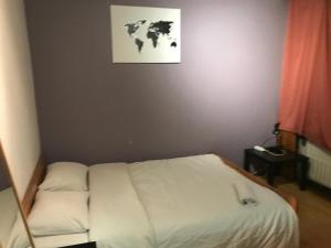 
a bedroom with a bed and a painting on the wall at Apartment Zaventem Brussels Airport D in Zaventem

