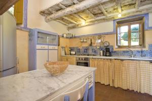 a large kitchen with blue and white appliances at Villa Bottino in San Martino in Freddana