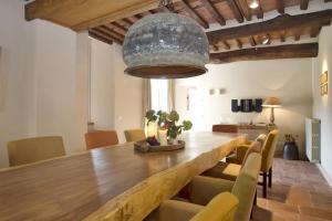 a dining room with a large wooden table and chairs at Villa Chiodo in Vorno