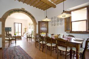 a kitchen and dining room with a table and chairs at Villa La Fonte in Palaia