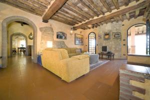 ein Wohnzimmer mit einem Sofa und einem Tisch in der Unterkunft Villa Le Rondini in Montopoli in Val dʼArno