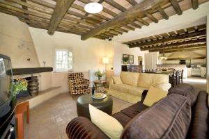 a living room with a couch and a table at Villa Teto in Collodi