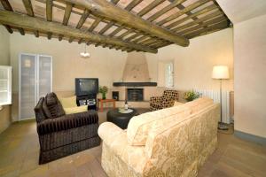 a living room with two couches and a fireplace at Villa Teto in Collodi