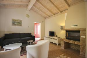 a living room with a black couch and a fireplace at Villa Nunica in Radetići