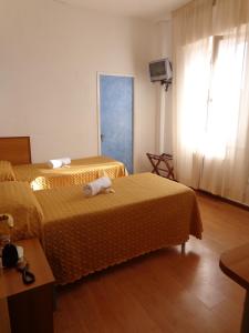 Postel nebo postele na pokoji v ubytování Hotel Loreto
