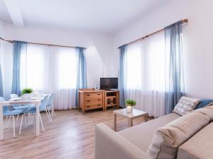 a living room with a couch and a table at VacationClub - Olymp Apartment 503 in Kołobrzeg
