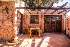 a patio with a table and a wooden door at Casa da Montanha in Luz
