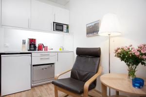 a small kitchen with a chair and a table at Northern Comfort Apartments in Reykjavík