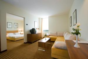 ザグレブにあるホテル ラグナ ザグレブの広いリビングルーム(ソファ、ベッド付)