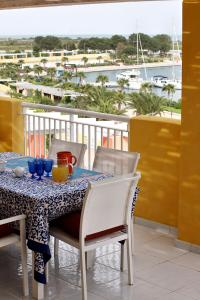 a table on a balcony with a view of a harbor at Argonauti Residence in Marina di Pisticci