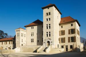 a large building with a tower on top of it at Tempologis - Chateau de la Rochette in Fontaine