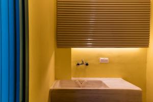 a bathroom with a tub with a window and a sink at Nubian Hostel in Athens