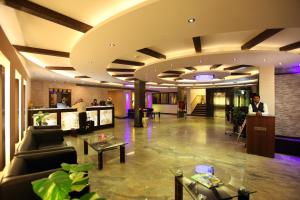 a lobby of a hotel with couches and a bar at Airport Hotel Le Seasons New Delhi in New Delhi