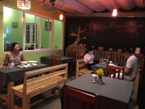 a group of people sitting at tables in a restaurant at Tina Bungalow in Phú Quốc