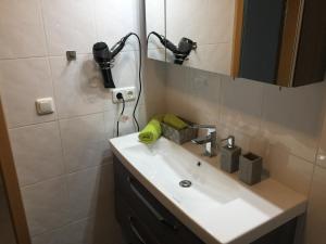 a bathroom with a sink and a mirror at Ferienwohnung CAI in Pfronten +15 photos