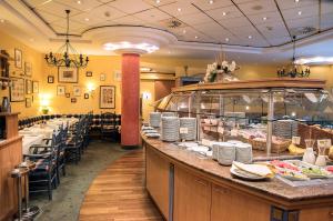 a restaurant with a buffet line with tables and chairs at Country Hotel Timmendorfer Strand in Timmendorfer Strand