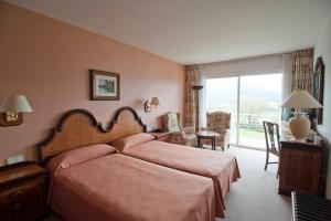 Postel nebo postele na pokoji v ubytování Hotel Riu Fluviá