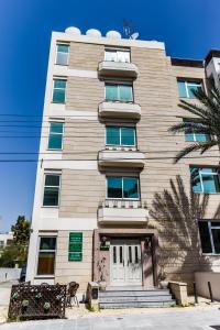 a tall tan building with a white door at Elysium Capital Residence in Nicosia