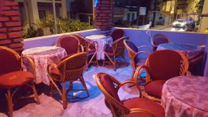 a row of tables and chairs with purple tables at GökMavi Pansiyon in Bodrum City
