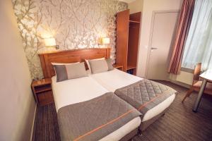 パリにあるティムホテル トゥール エッフェルのホテルルーム内のベッドルーム1室(大型ベッド1台付)