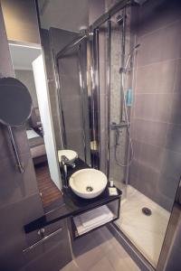a bathroom with a sink, toilet and shower stall at Timhotel Tour Eiffel in Paris