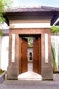 an entrance to a building with a wooden door at Nomad Hub Canggu Bali in Canggu
