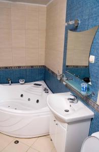a bathroom with a tub and a sink at Guest house Lidia in Tsigov Chark +34 photos