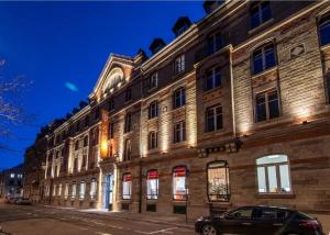 a large building with a car parked in front of it at Ciarus in Strasbourg