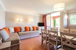 a living room with a couch and a table at Résidence Pierre & Vacances Les Rives de Cannes Mandelieu in Mandelieu-la-Napoule
