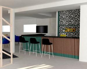 a kitchen with a bar with stools and a tv at ibis Styles Marseille Plan de Campagne in Les-Pennes-Mirabeau