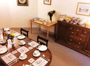 a dining room with a table and a dresser at Lamb Inn Guesthouse in Congleton