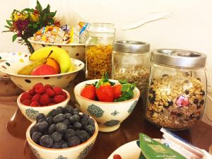 a table with bowls of fruit and jars of food at Lamb Inn Guesthouse in Congleton