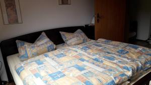 a bed with a comforter and pillows on it at Ferienwohnung Gareus in Zittenfelden
