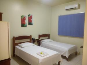 Кровать или кровати в номере Hotel Goiânia