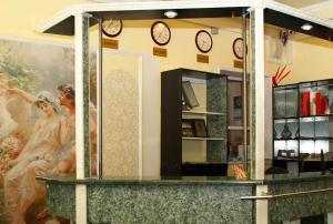 a store with clocks on the wall and a counter at Парк-отель Усадьба in Moscow