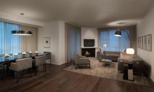 a living room with a table and a dining room at AKA Beverly Hills in Los Angeles