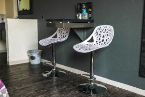 a pair of stools sitting on top of a counter at Hotel La Luna in Mexico City
