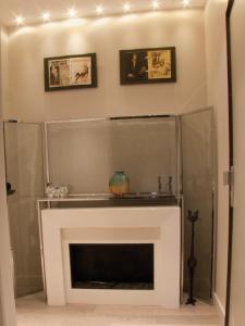 a fireplace in a living room with lights above it at La Maison de Léa in Paris