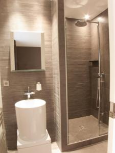 
a bathroom with a toilet, sink, and shower at La Maison de Léa in Paris

