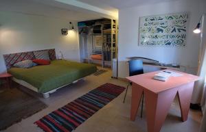 a living room with a bed and a table at Natural Reserve Apartment in Zikhron Ya'akov